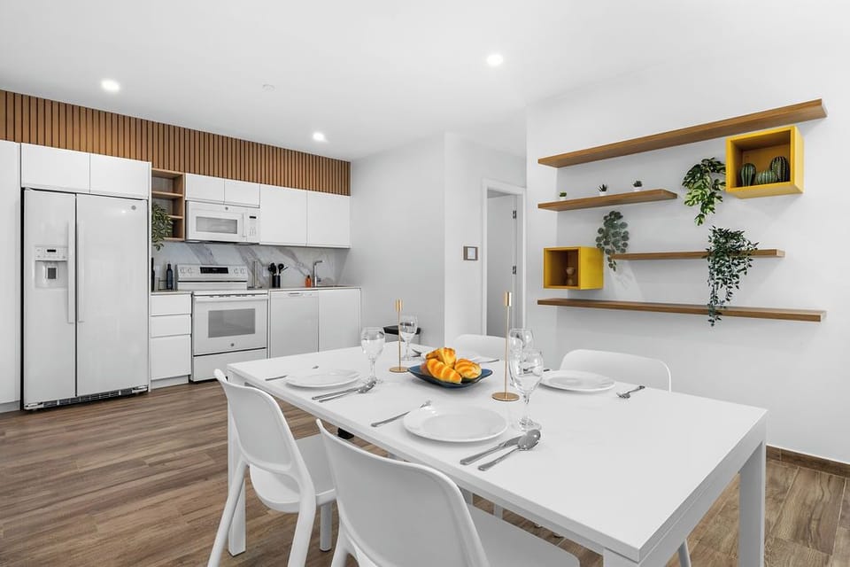 Modern dining area with a stylish table seating four.