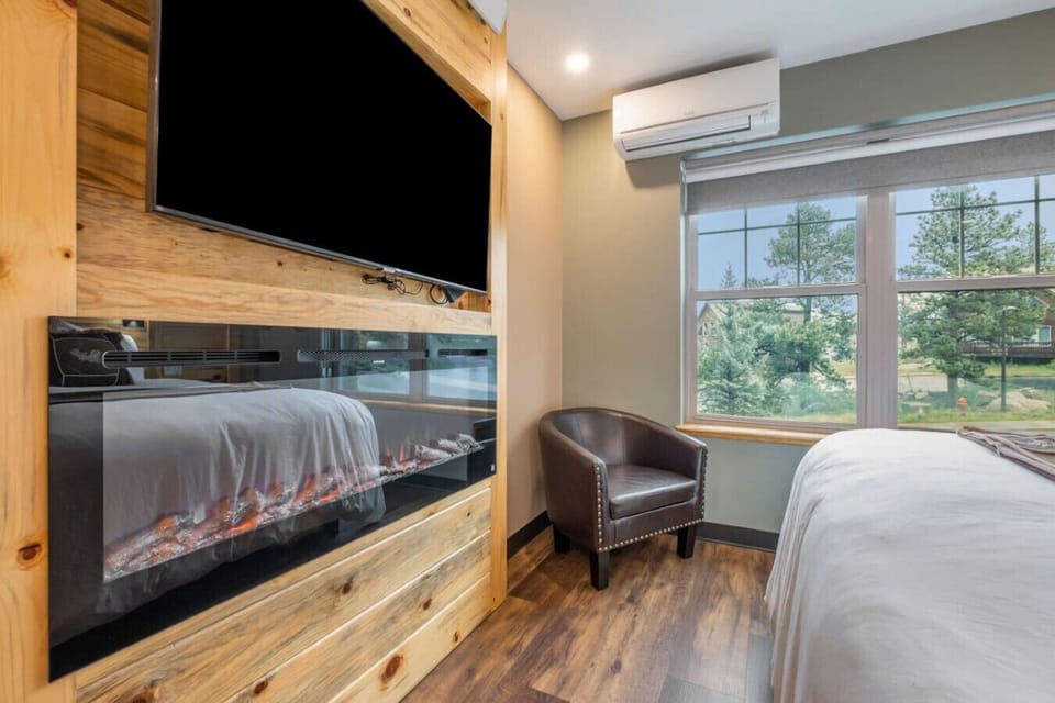Electric fireplace and smart TV in front of the big king bed