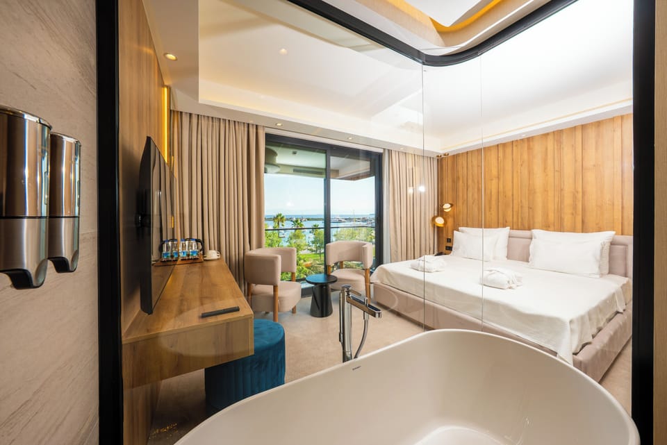 Deluxe Suite, Balcony, Sea View | Bathroom | Free toiletries, hair dryer, slippers, towels