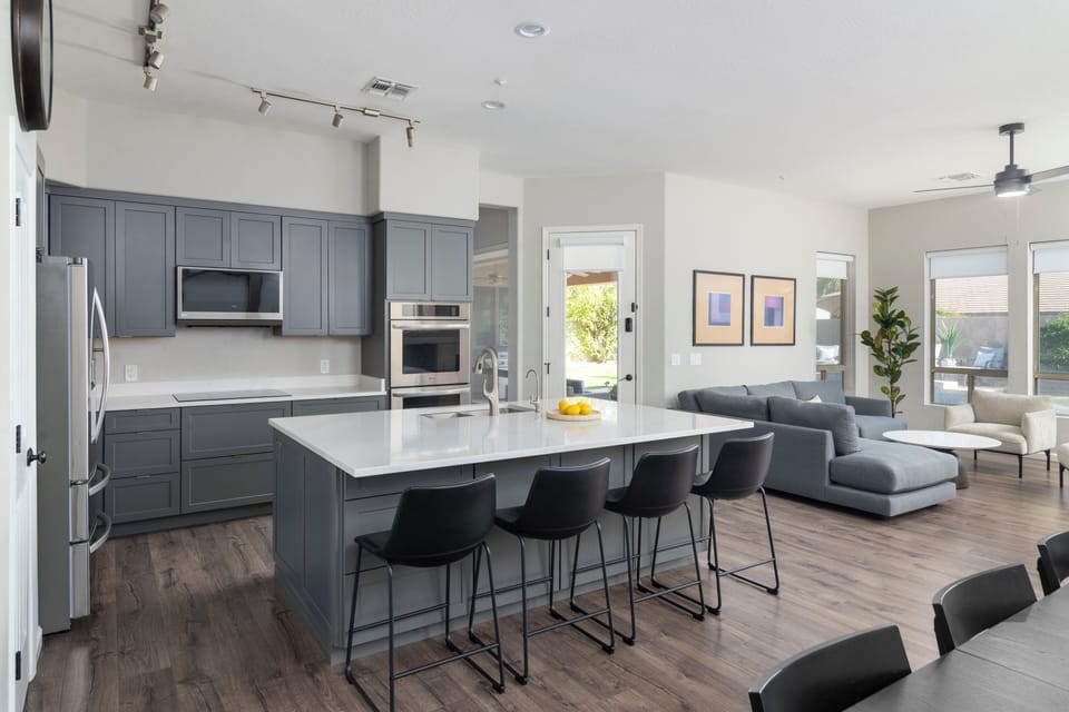 Modern kitchen with double ovens, oversized island, and open gathering space