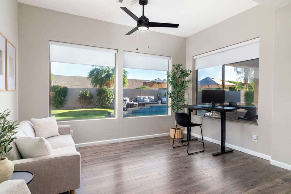 Dedicated workspace with natural light and pool views