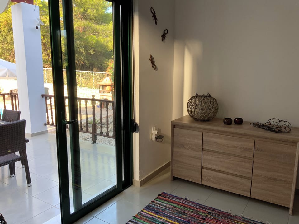 Door from the lounge leading onto the pool terrace which overlooks the pool.