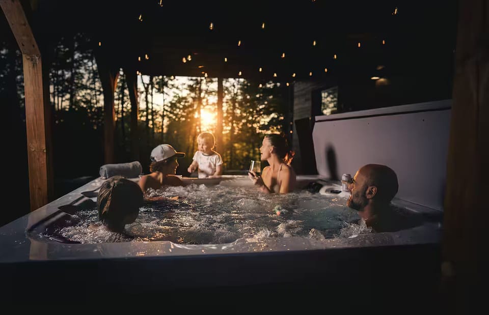 Four-season outdoor hot tub with forest views