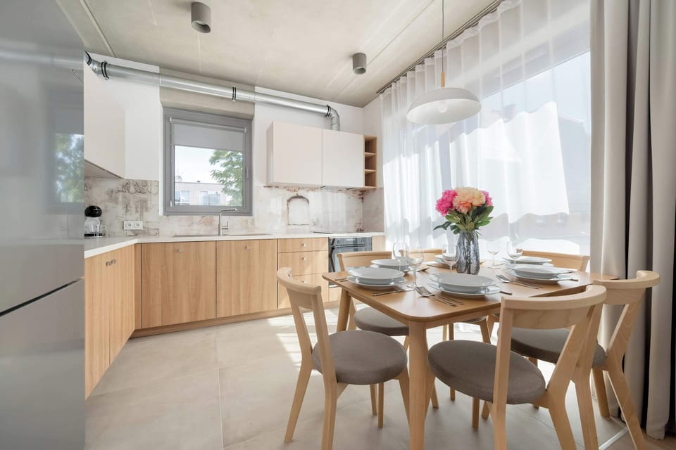 A fully equipped kitchenette with modern wooden cabinets and built-in appliances. Practical and stylish for everyday cooking.