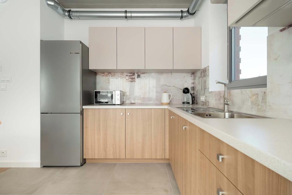 An open kitchenette connected to the dining area. Functional and stylish for shared meals.