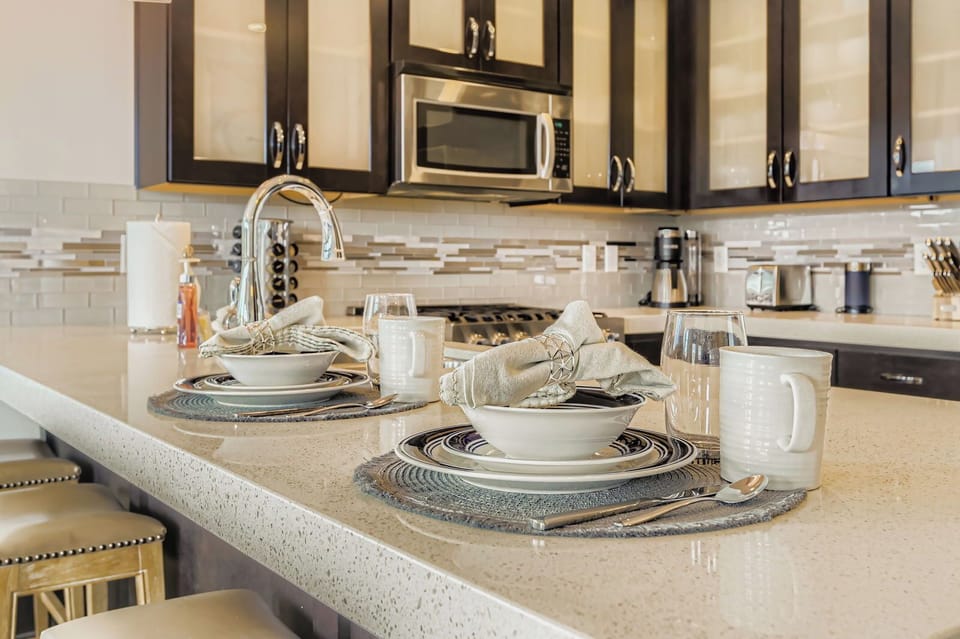 Whip up local delicacies in this sleek, modern kitchen at Blackstone. Enjoy stainless steel appliances, elegant pendant lighting, and a spacious breakfast bar perfect for quick morning bites.