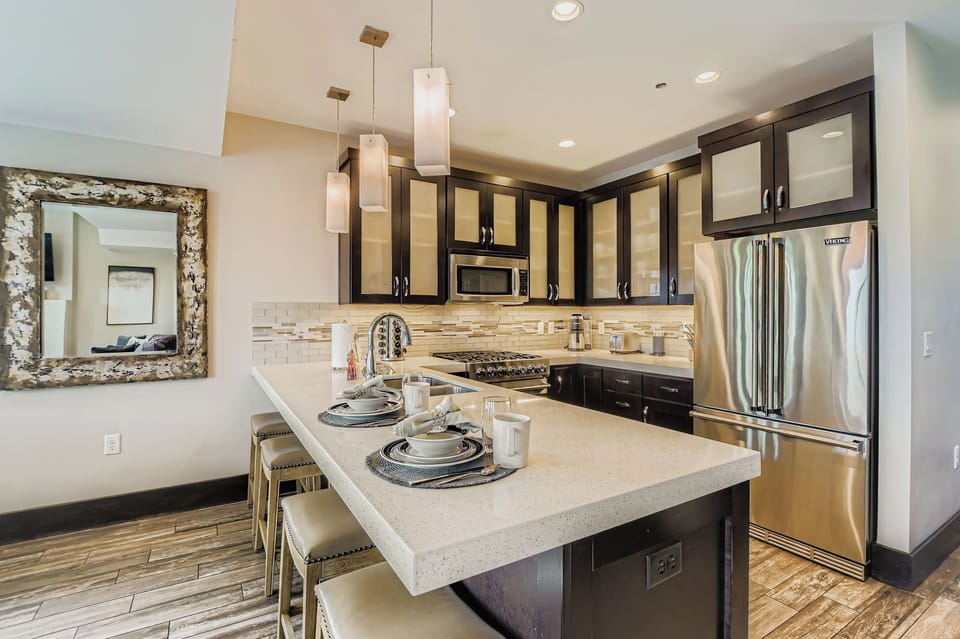 Whip up local delicacies in this sleek, modern kitchen at Blackstone. Enjoy stainless steel appliances, elegant pendant lighting, and a spacious breakfast bar perfect for quick morning bites.