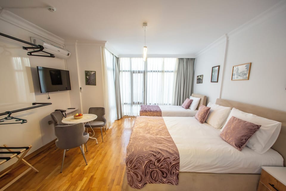 Family Triple Room, City View | Premium bedding, minibar, in-room safe, blackout drapes