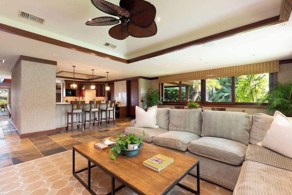 Open-concept living room with garden views and comfortable, upscale seating.