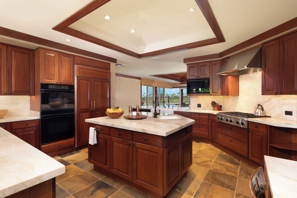 Central island and tray ceiling highlight this chef-ready kitchen.