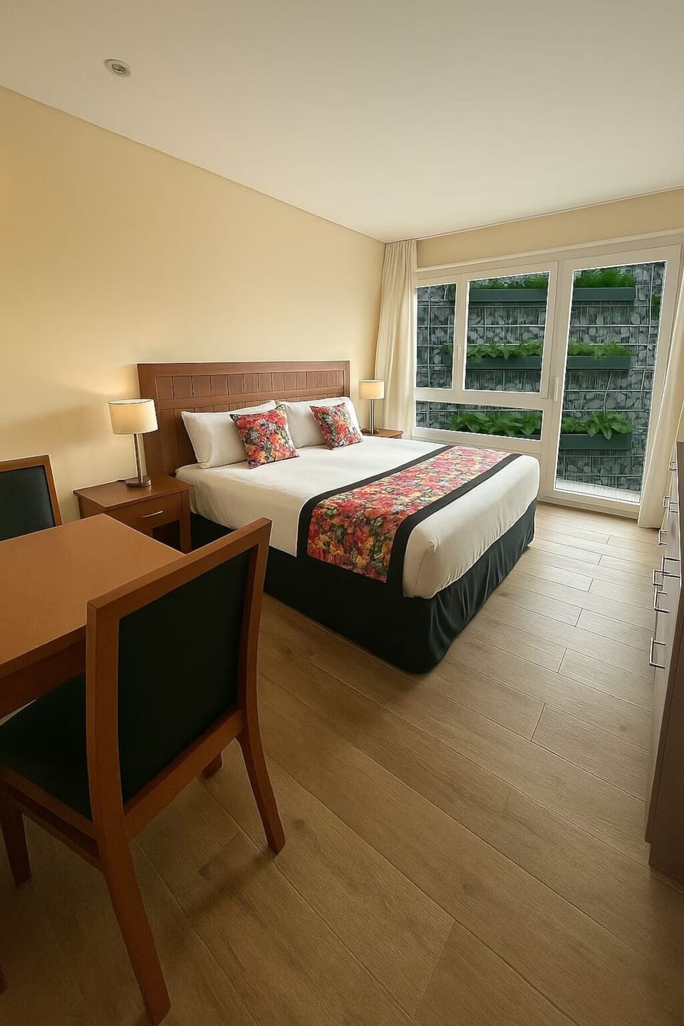 Settle into a quiet bedroom with desk and wide window.