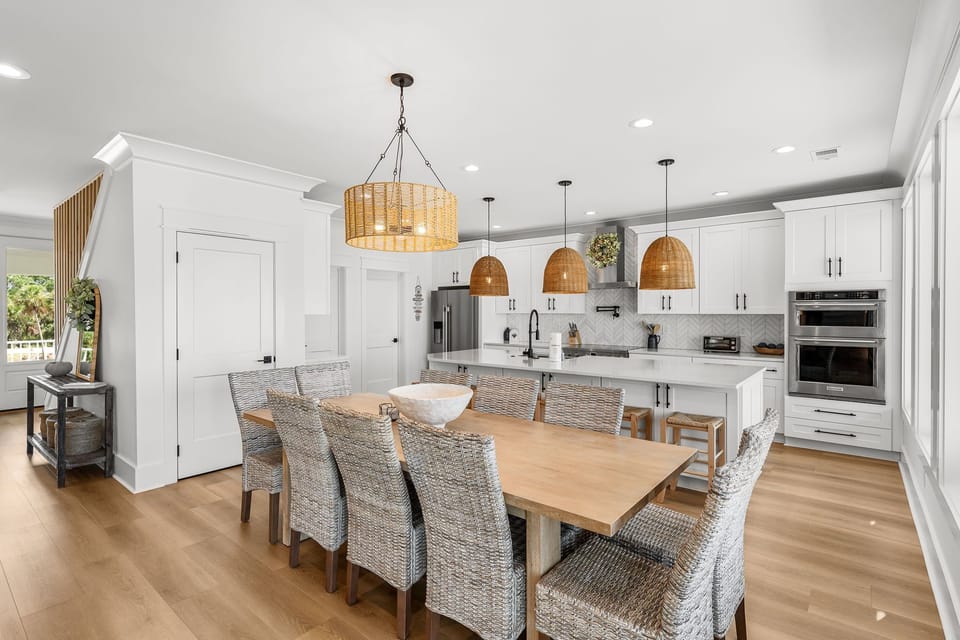 Gather around this stunning dining table where warm wood meets elegant wicker, creating the perfect spot for your memorable meals together.