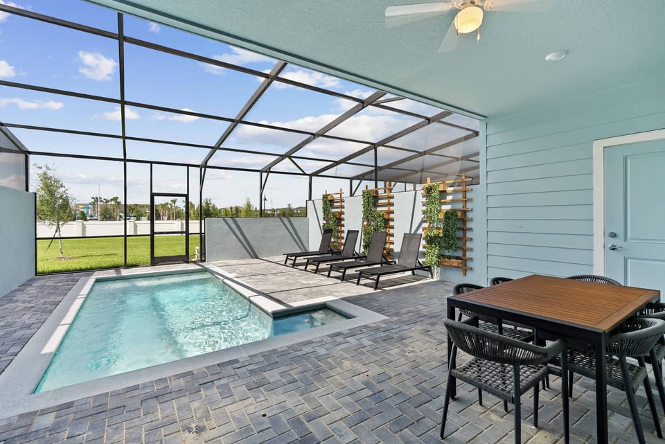 Step outside to your private oasis featuring a sparkling pool framed by sleek pavers and shaded lounge chairs. The spacious screened area invites you to relax at the dining table, all while enjoying the fresh air and open views.