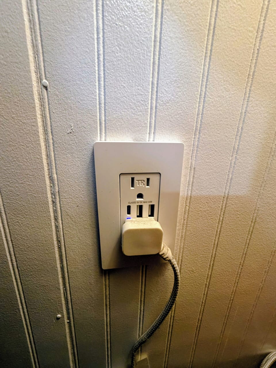 USB outlet for convenient phone charging located beside the couch