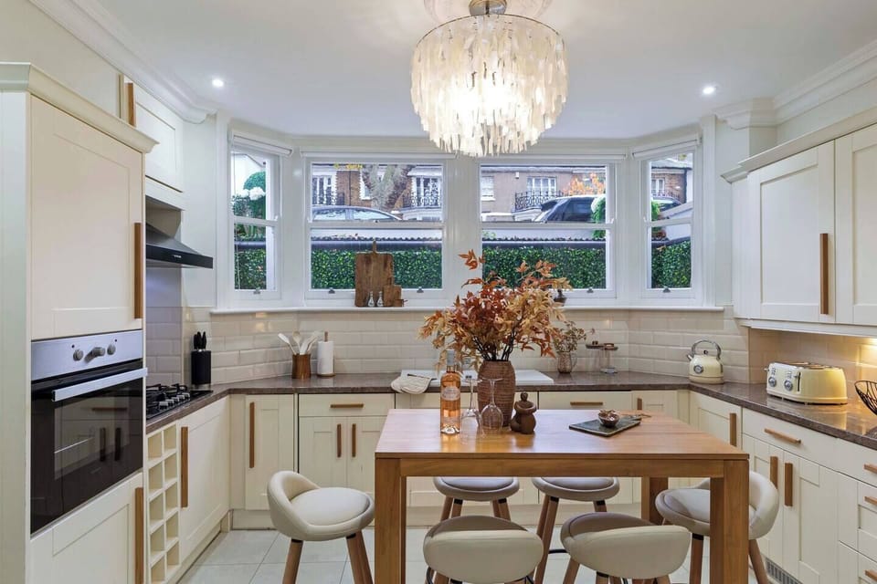 Fully fitted basement kitchen with integrated appliances including a dishwasher, washing machine, separate dryer, gas hob, wine cooler, fridge freezer, single oven, microwave, coffee machine, tv, kettle and toaster.
