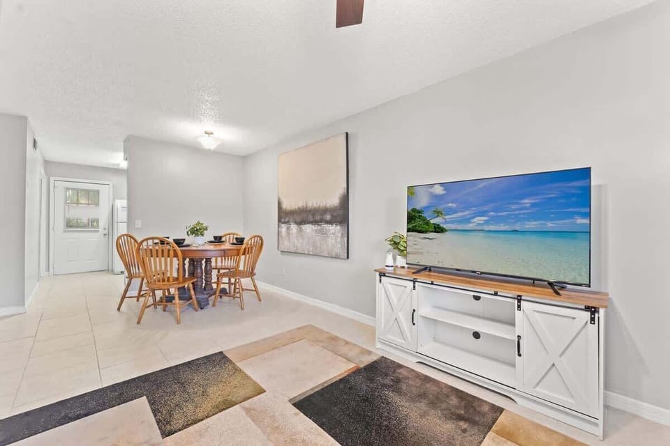 Living Room offers a comfortable sectional sofa to lounge in while watching the 55" Roku Smart TV. 