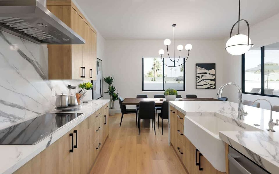 Fully equipped kitchen with stainless steel appliances, a sleek kitchen island with a breakfast bar for casual seating for 4, plus a large dining table for 10. (1st Floor)