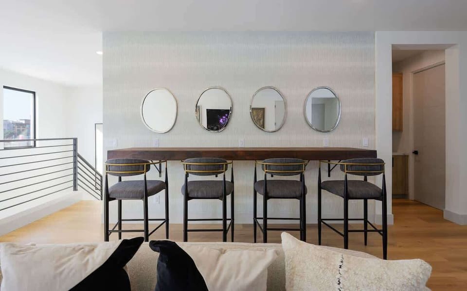 2nd living/game room with bar seating for 4, designer furnishings, smart TV, foosball table, and metal dartboard. (2nd Floor)