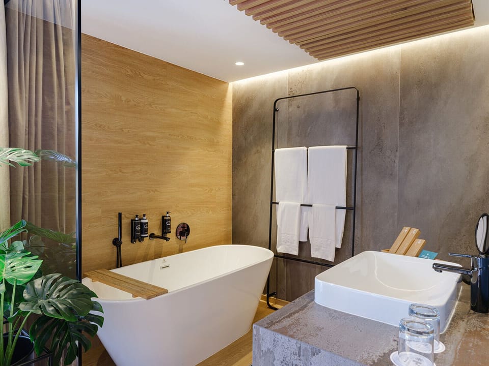 Grand Suite Essence | Bathroom | Hair dryer, towels, soap, shampoo