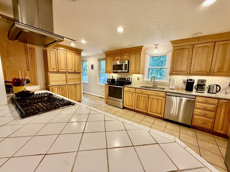 Kitchen island with bar stools and modern appliances.