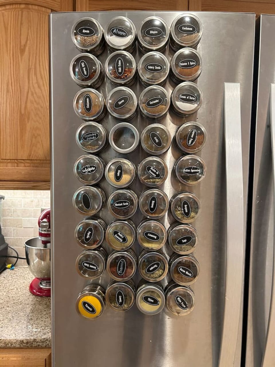 Magnetic spice rack with assorted seasonings.