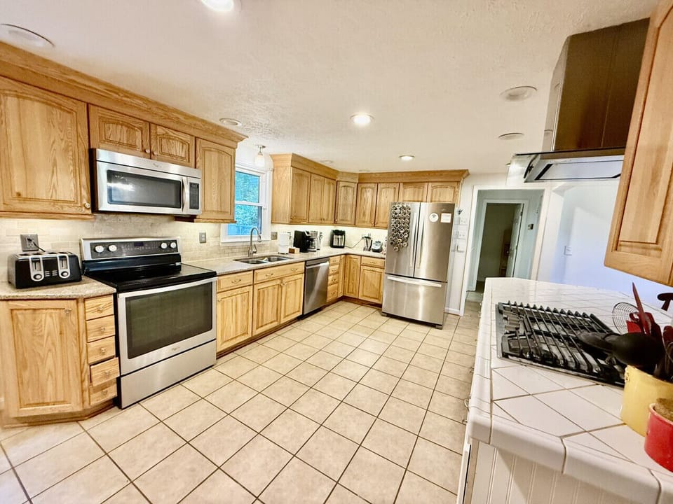 Kitchen island with bar stools and modern appliances.