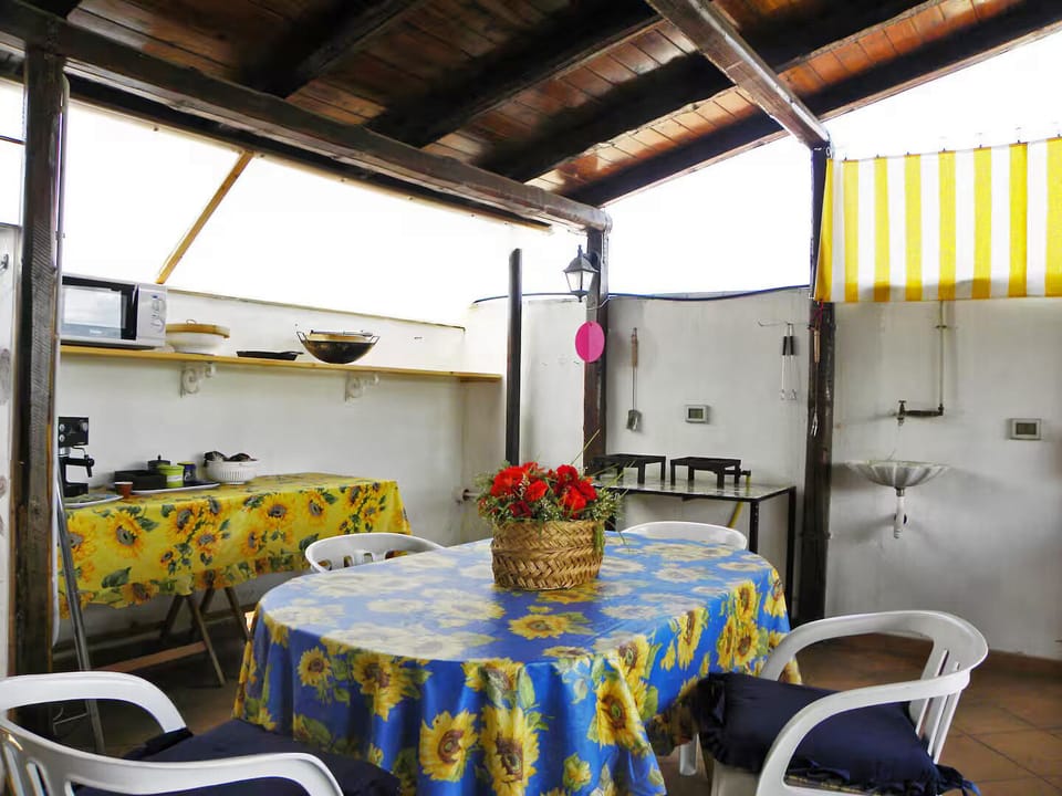 The kitchenette dining table next to cooking and barbeque areas on the main deck