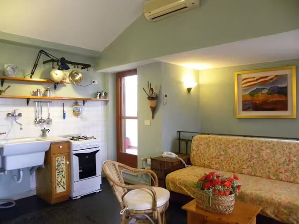 Living room / kitchen with exterior door leading to the Terrace