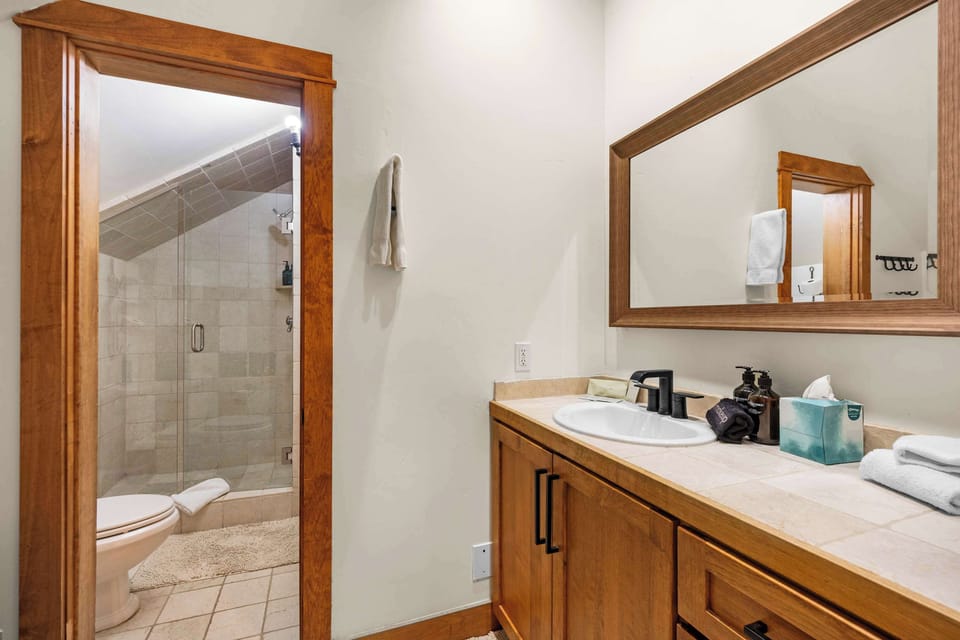 Bathroom 3 (upper floor): En-suite with walk-in shower, single sink