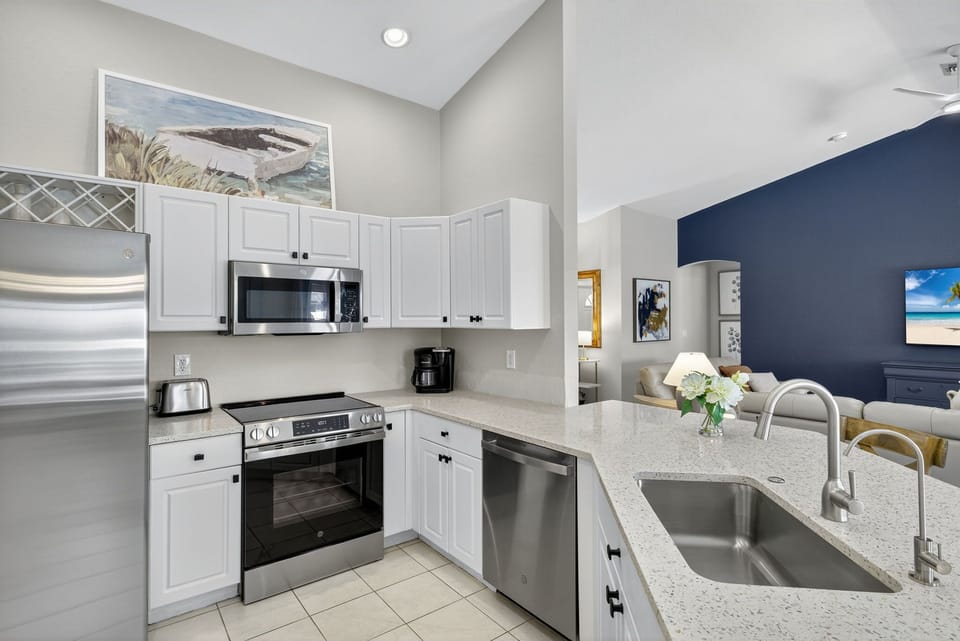 NEW coastal quartz countertops perfectly fit the kitchen space.