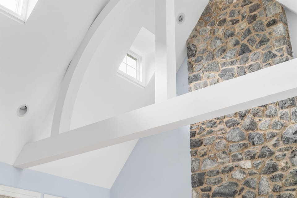 Vaulted ceiling and stonework highlight the home’s architectural charm