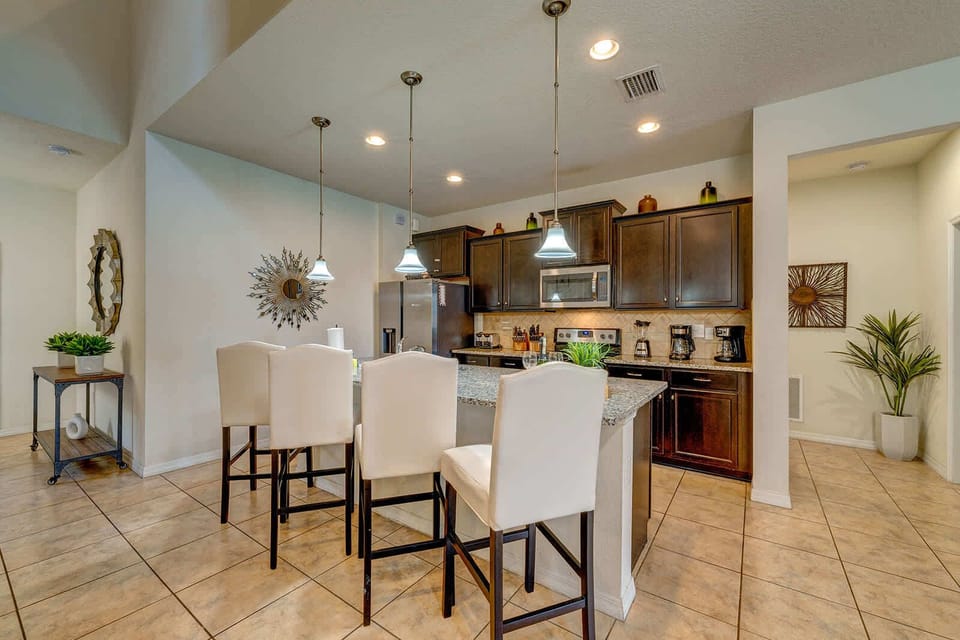 Modern kitchen with granite island and seating for four.