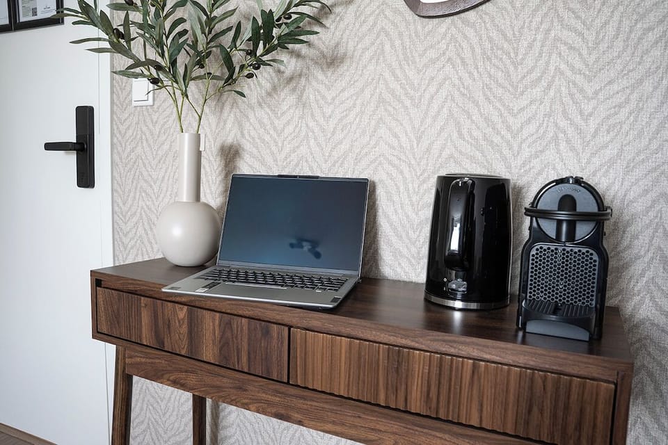 Work or relax with a stylish desk setup, complete with coffee machine, kettle, and chic décor.
