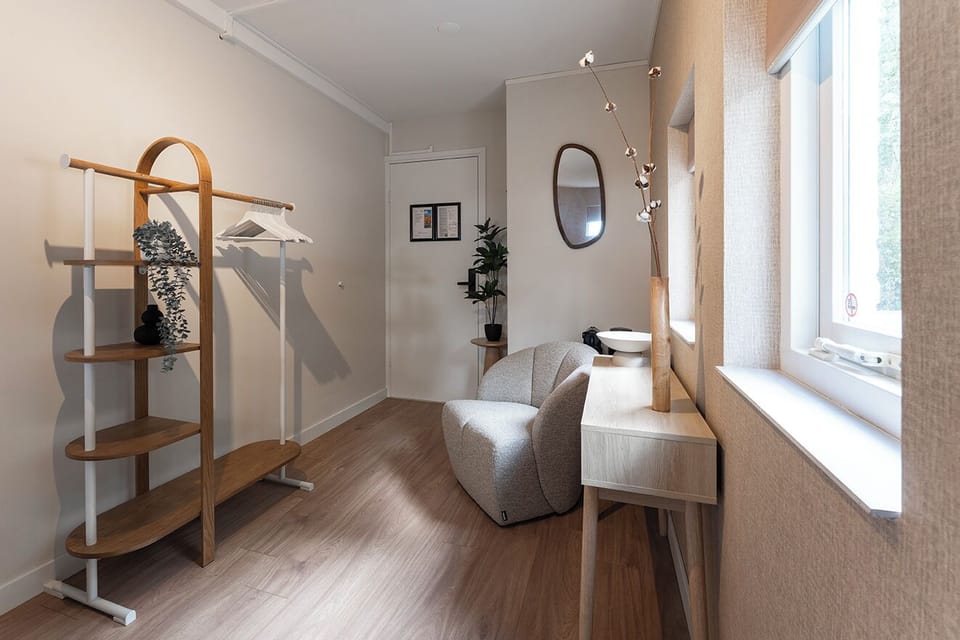 A modern retreat with neutral tones and chic details. Relax in the cozy chair, enjoy a coffee, or simply take in the calm ambiance of the space.