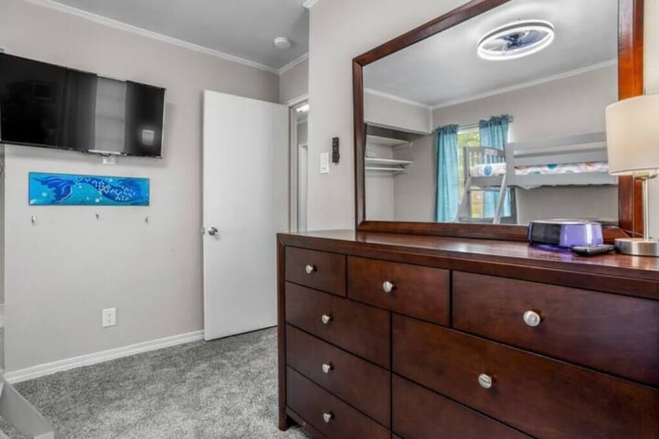 The bunk room has modern amenities like a smart TV, creating a peaceful retreat for a restful night.
