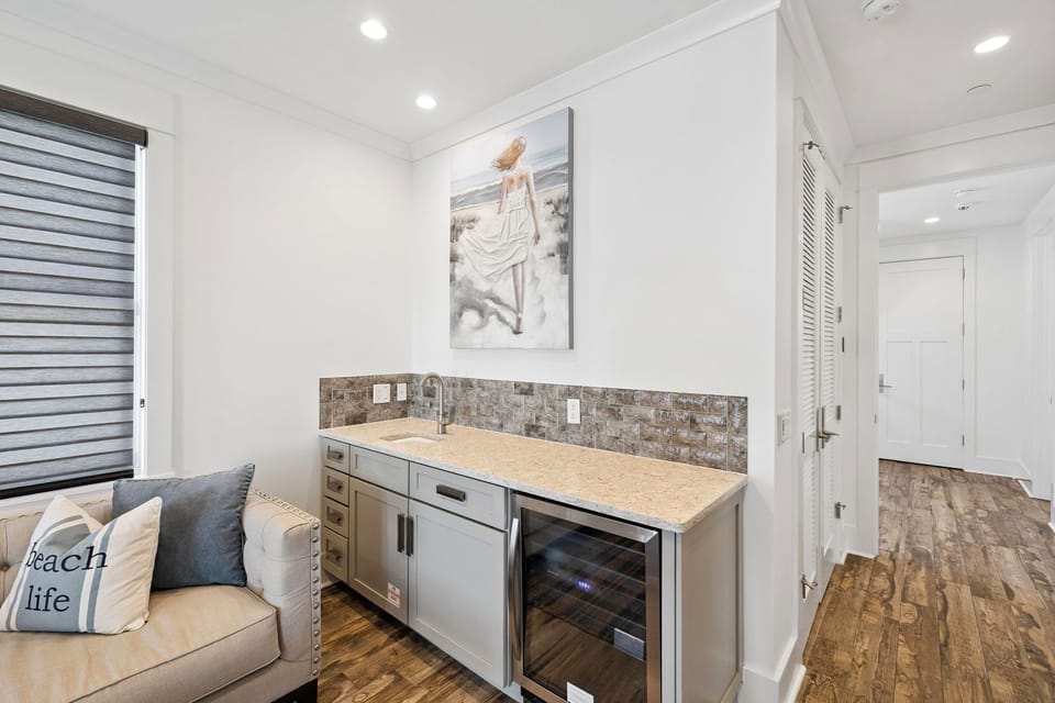 Your stylish wet bar with wine fridge and stone backsplash creates the perfect spot for evening cocktails.