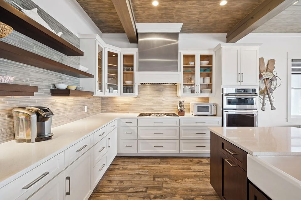 Create memorable meals in this stunning gourmet kitchen featuring gleaming countertops, premium appliances, and warm wood beam ceilings overhead.