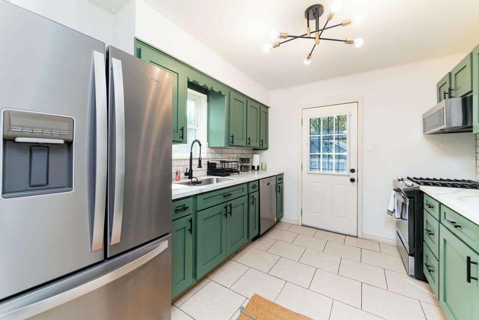 All recent appliances with a dishwasher, stainless steel gas grill and microwave