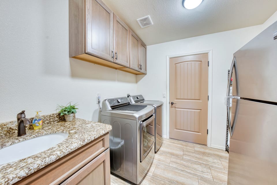 Laundry room with washer & dryer, plus sink.  2nd refrigerator & extra shelving