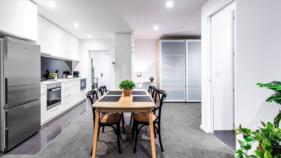 Long open-plan layout blending dining, kitchen, and living seamlessly.