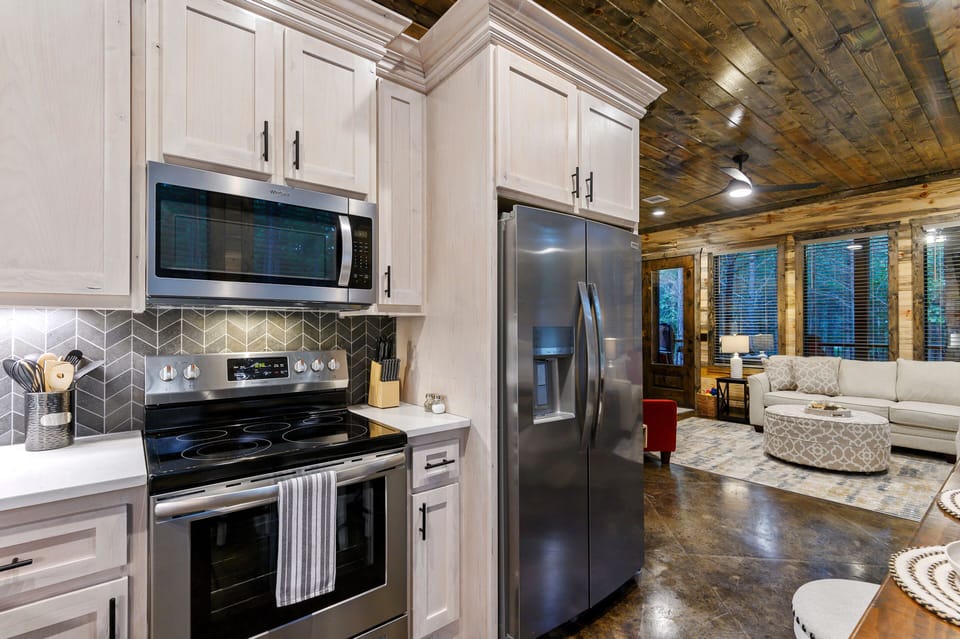 Rustic kitchen and living room with wood accents and natural light.