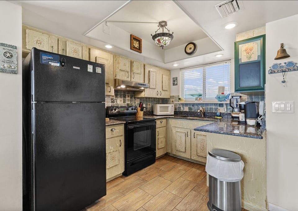 Cook with ease during your beach stay in this fully equipped kitchen featuring modern appliances, ample counter space, and coastal charm—perfect for family meals and vacation dining.