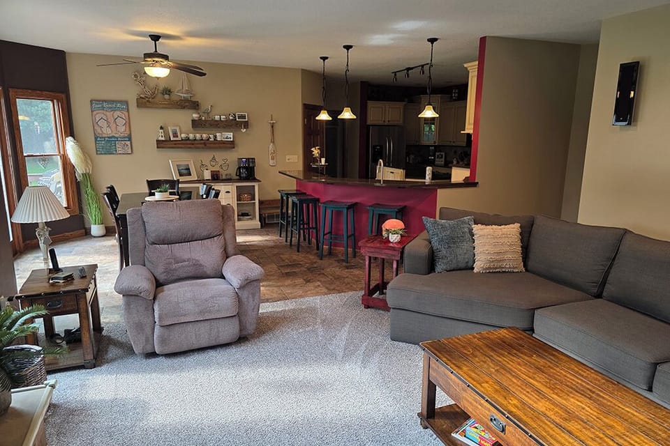Family room with new carpet, looking into kitchen area