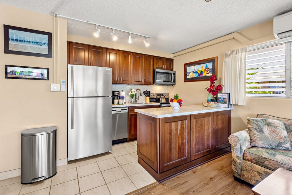Cook with ease in the fully equipped kitchen, featuring sleek stainless steel, full-size appliances perfect for preparing anything from quick snacks to full dinners.