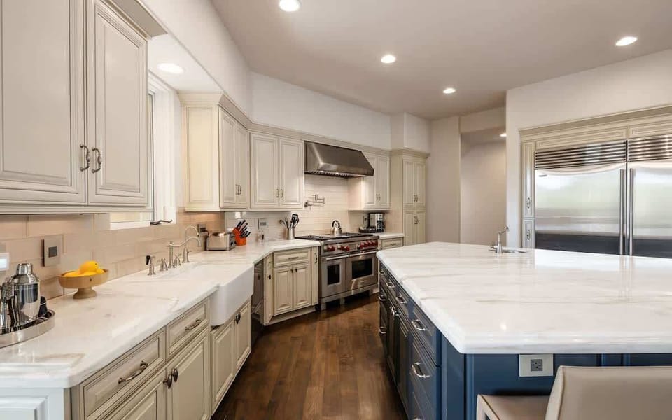 Fully equipped kitchen with stainless steal appliances, mini wine cooler, ice maker, and a kitchen island with bar seating for 4 guests.