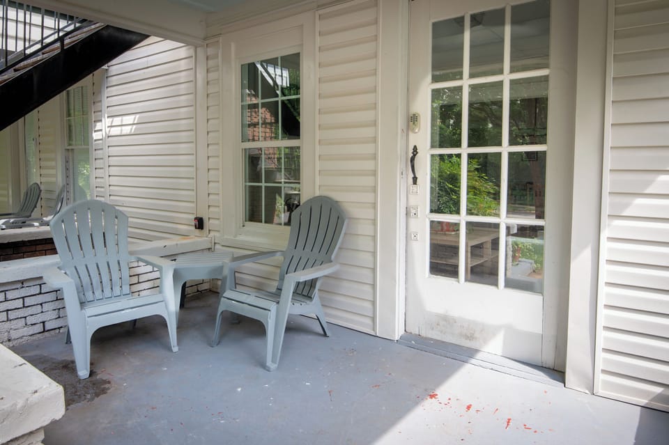 Charming covered patio with outdoor seating, perfect for your morning coffee or evening unwind.