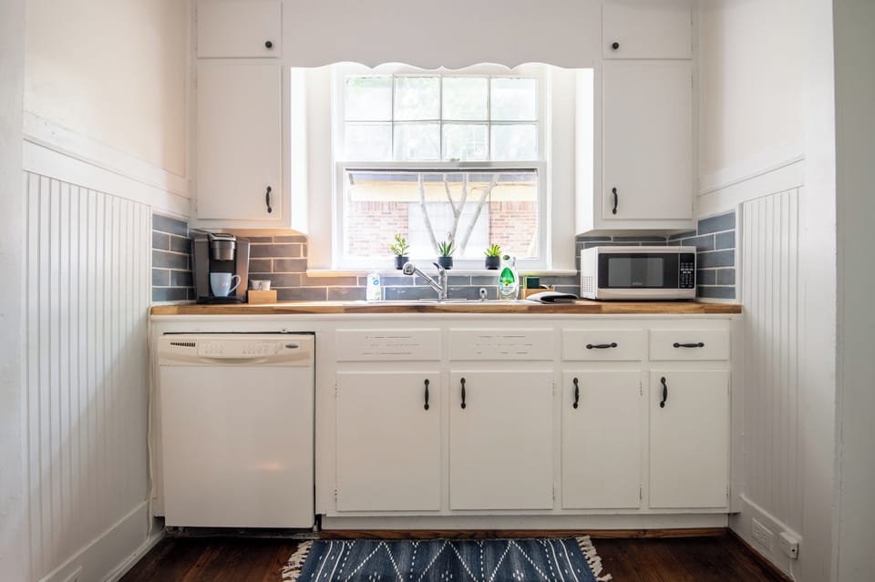 Sunny kitchen  with coffee maker, toaster, and microwave to start your mornings right.
