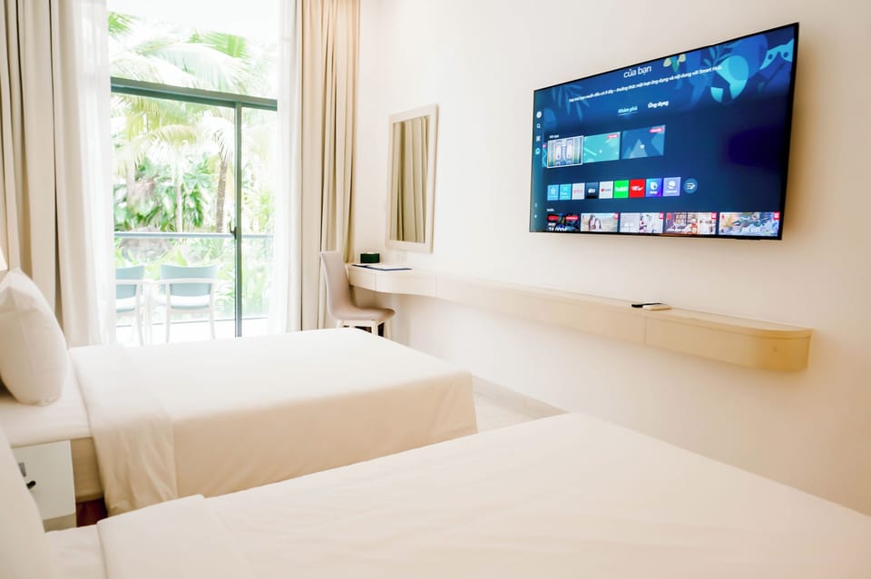 Costa Deluxe Twin With Balcony | Premium bedding, minibar, desk, free cribs/infant beds