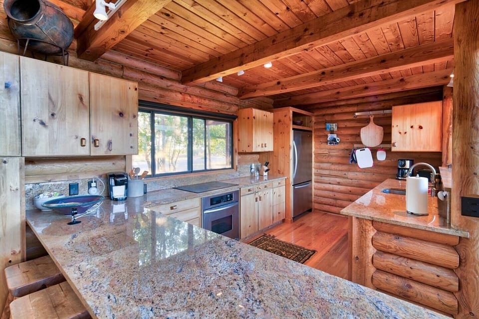 The bright, open kitchen has stainless steel appliances, granite countertops, and everything you'll need to whip up a delicious meal.