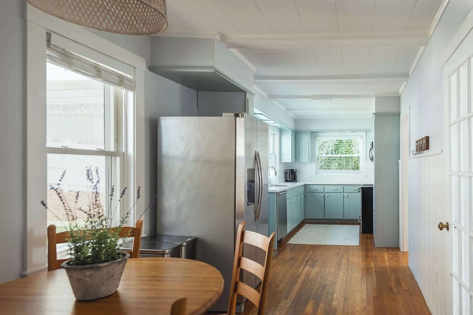 Open kitchen and dining area with bright windows